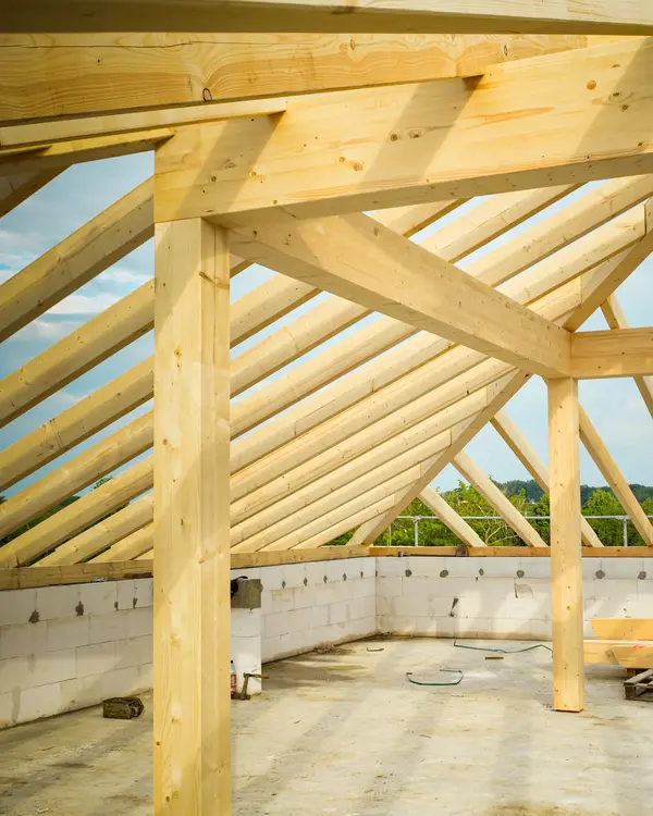 The roof trusses of a new house, sky showing through
