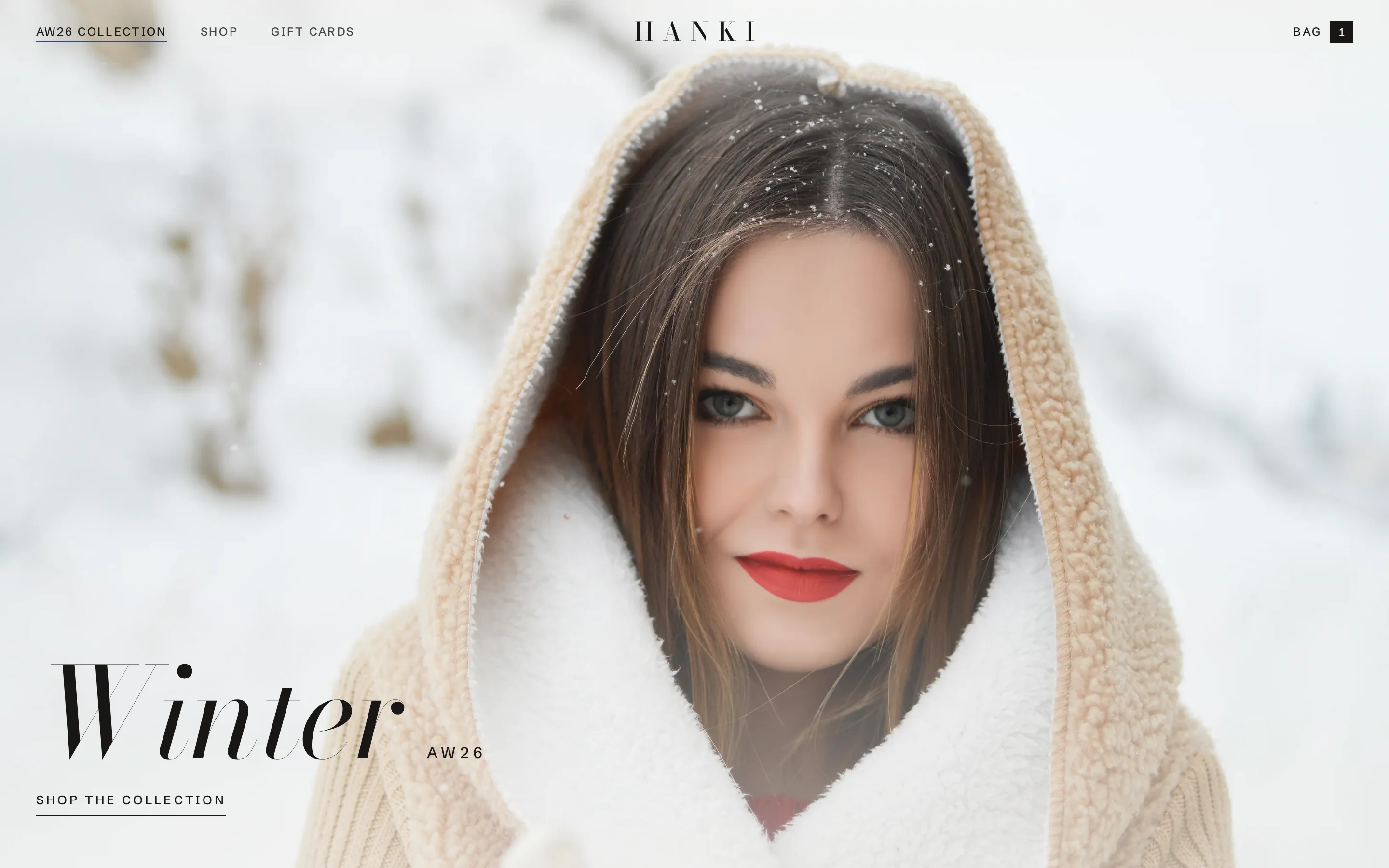 HANKI's finished front page: a hooded knit coat in the snow across the whole screen and the title Winter AW26.